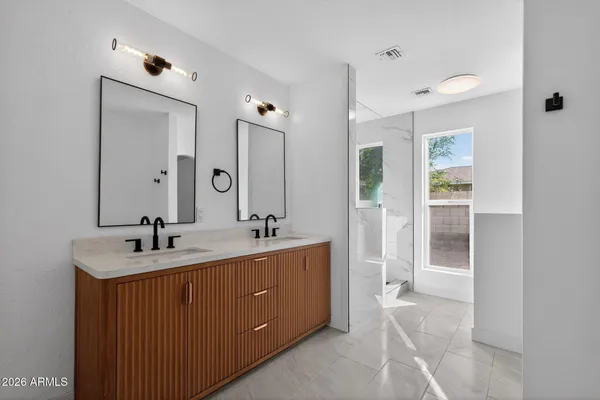a bathroom with a sink vanity granite tub and shower
