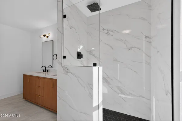 a white bath tub sitting next to a white wall