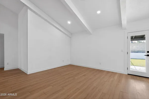 a view of a room with wooden floor