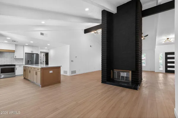 a view of kitchen with refrigerator and window