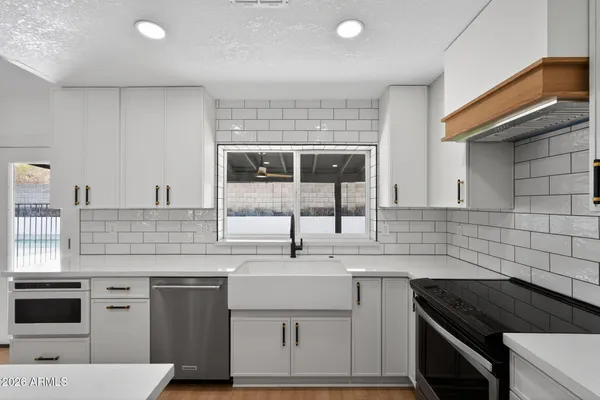 a kitchen with a sink stove and cabinets