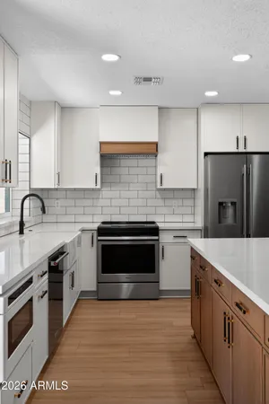 a kitchen with a sink stove and refrigerator