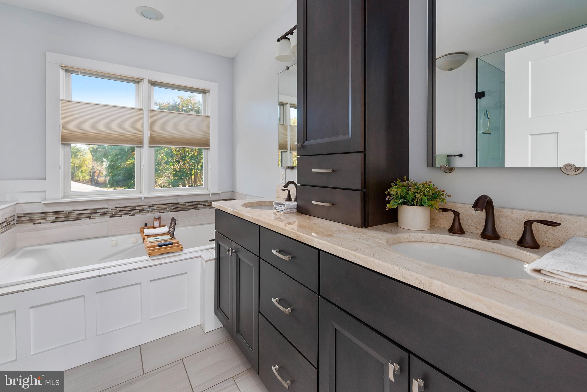 602 Old Point Road Chester, MD 21619 - Photo 22 of 51 a bathroom with a sink double vanity granite tub and a window