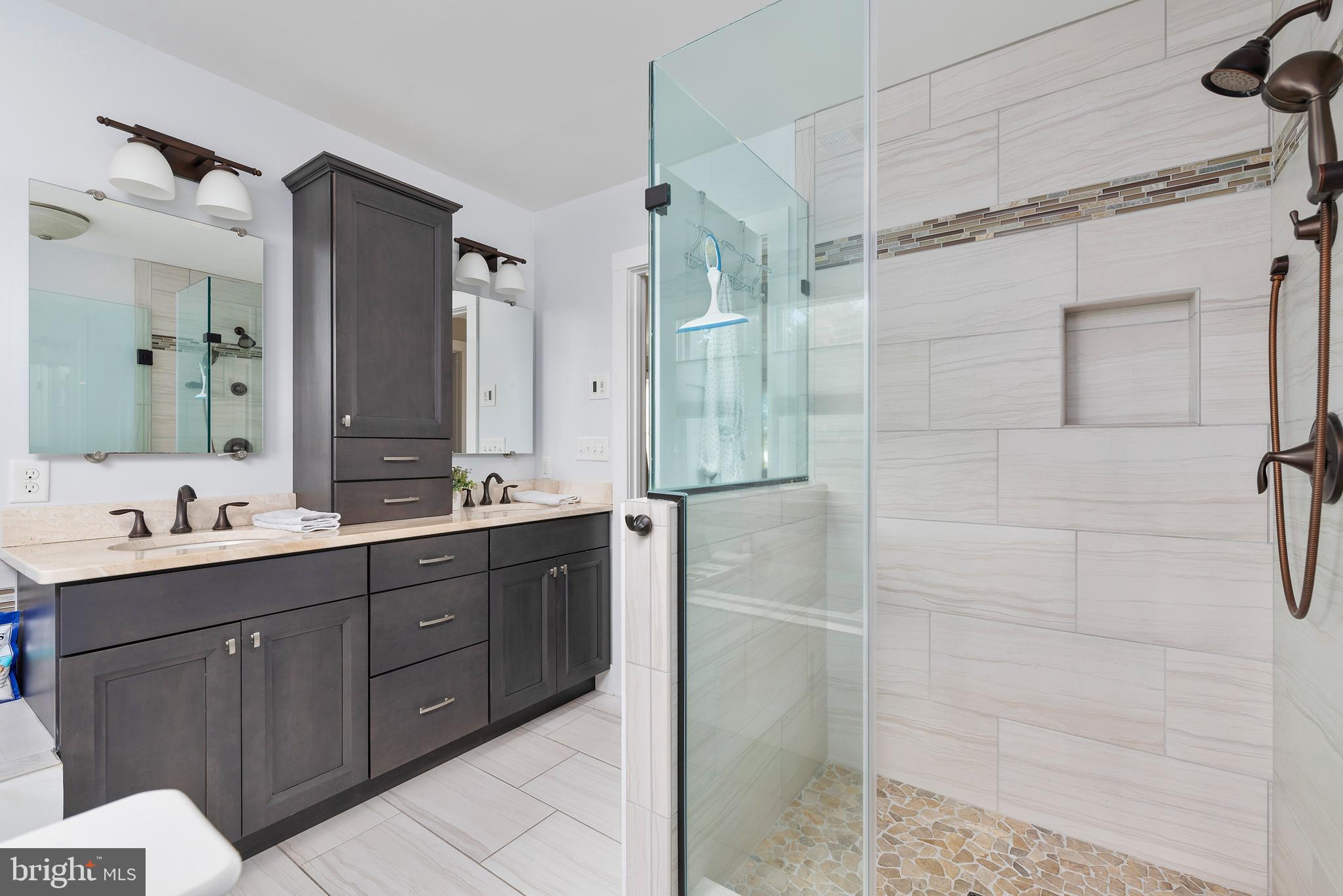 602 Old Point Road Chester, MD 21619 - Photo 23 of 51 a bathroom with a double vanity sink mirror and shower