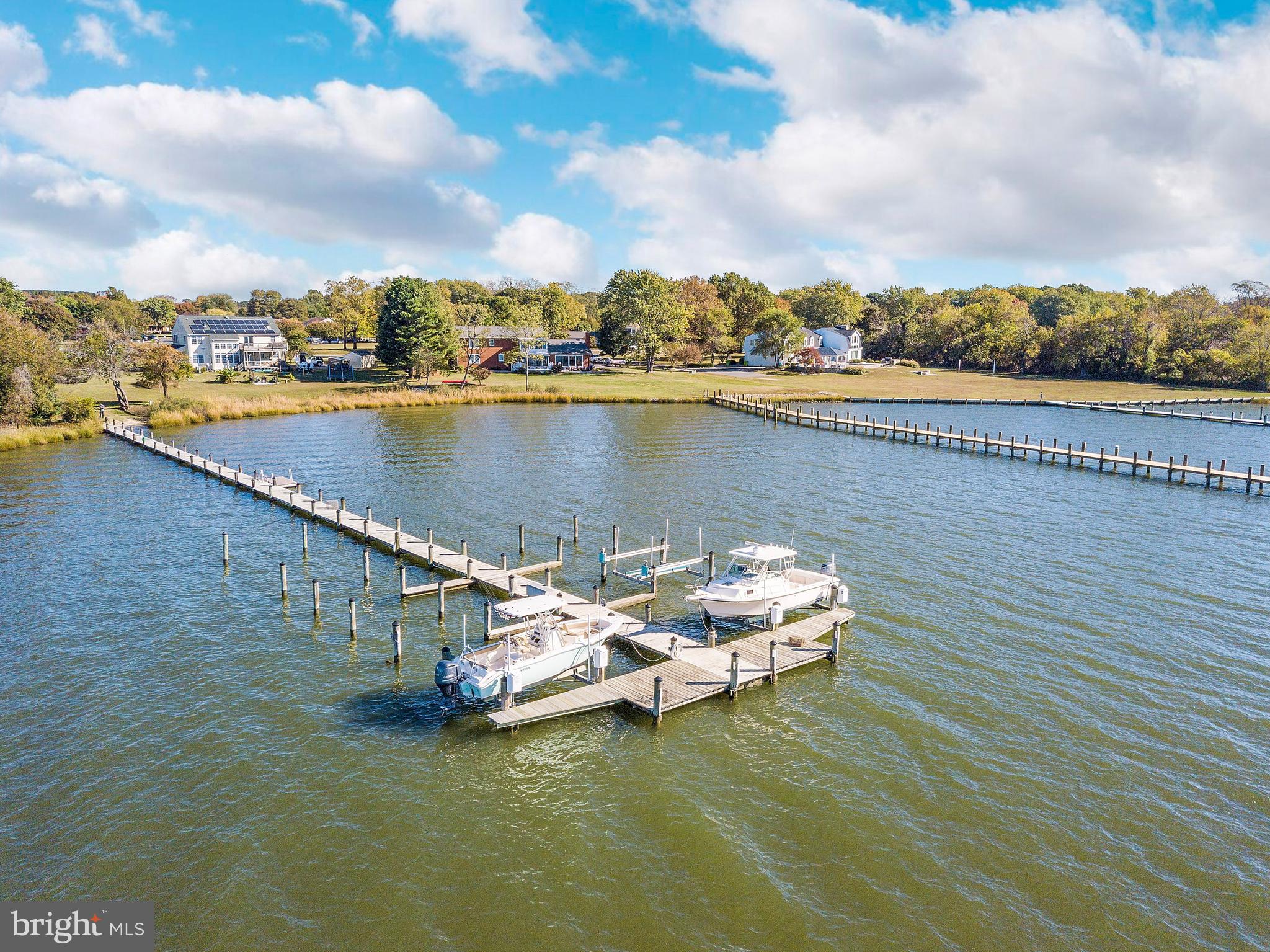 602 Old Point Road Chester, MD 21619 - Photo 39 of 51 a view of a lake with a table and chairs