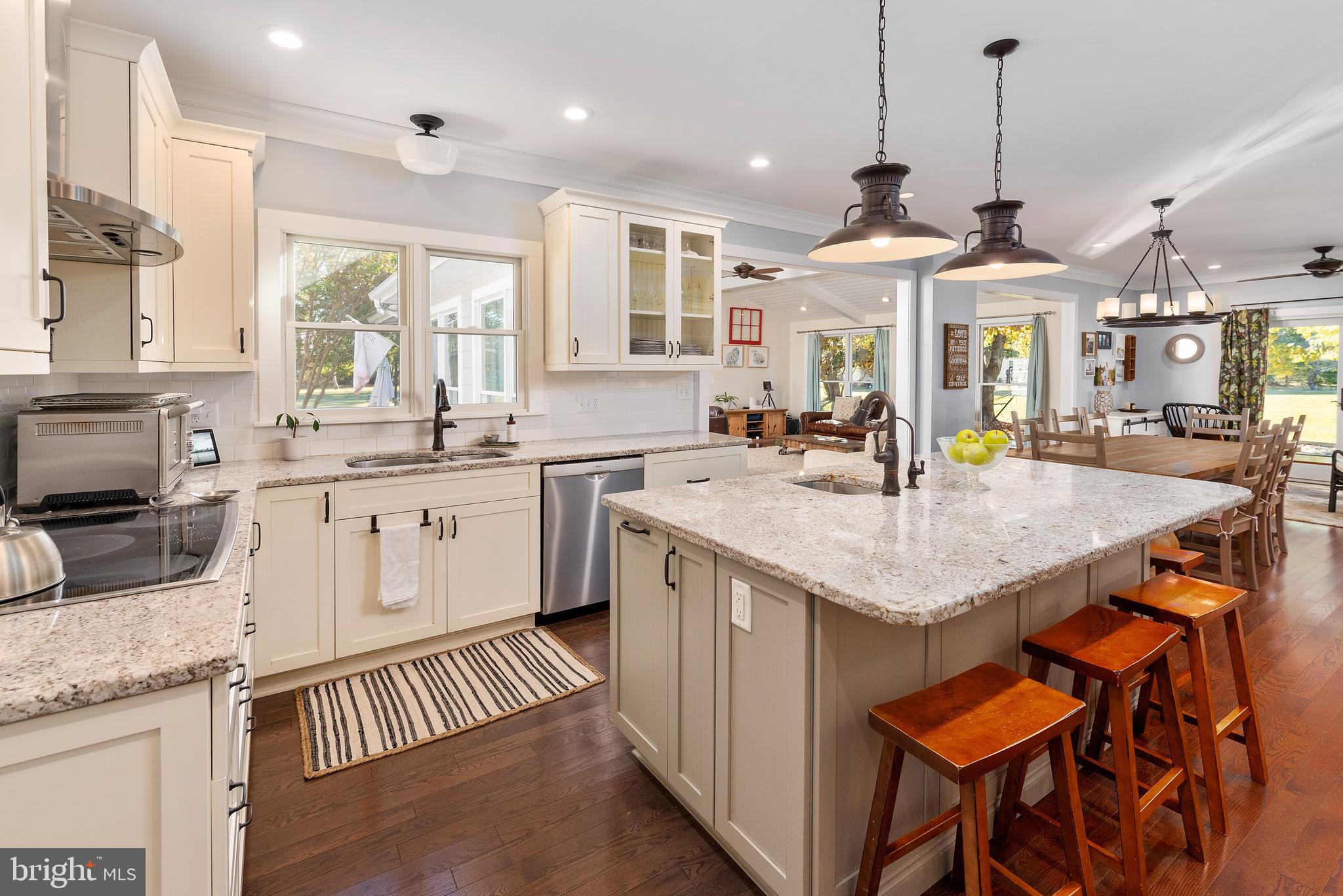 602 Old Point Road Chester, MD 21619 - Photo 7 of 51 a kitchen with stainless steel appliances kitchen island granite countertop a sink and cabinets