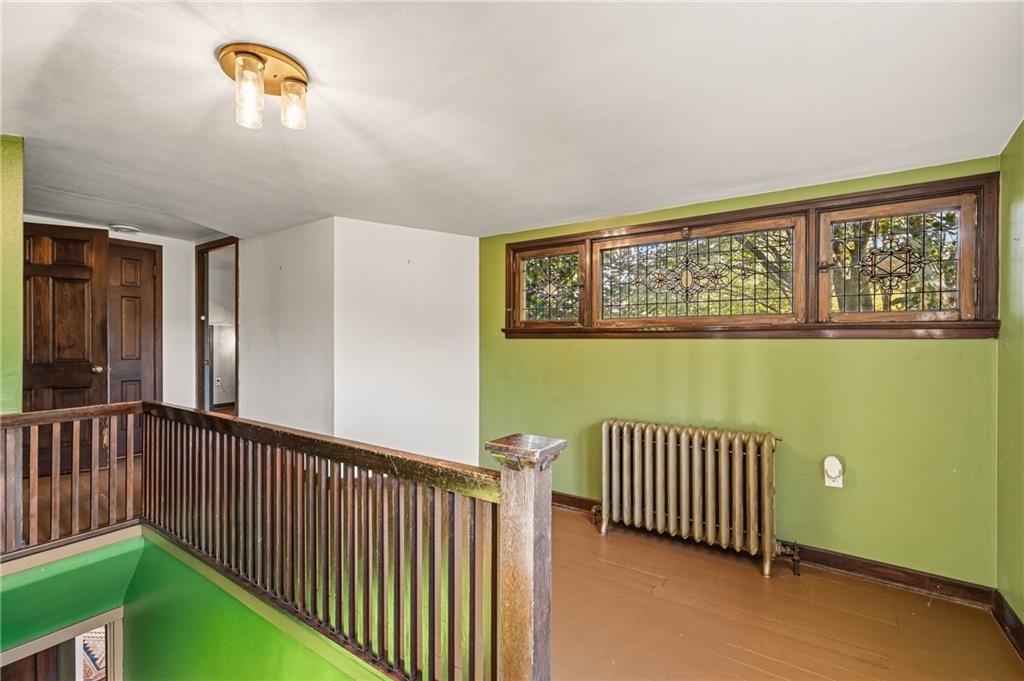 218 Elmore Road Pittsburgh, PA 15221 - Photo 16 of 34 Landing at the top of the stairs is large enough for a small office or reading nook under the cut glass windows