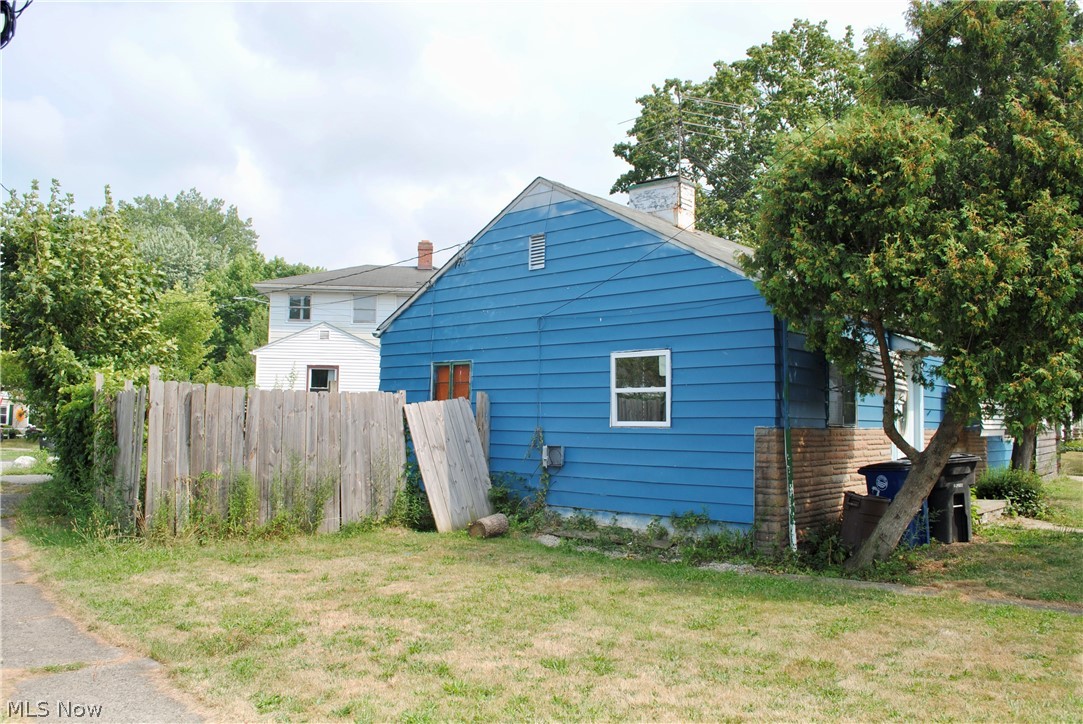 3775 Highland Road Cleveland, OH 44111 - Photo 2 of 11 Blue siding exterior with a pitched roof and a white-framed window