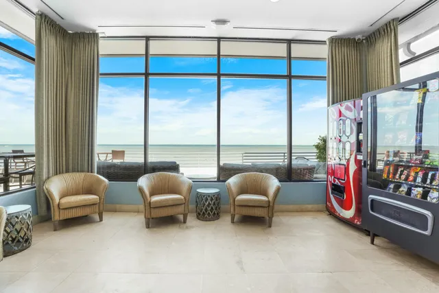 a bedroom with furniture and a large window