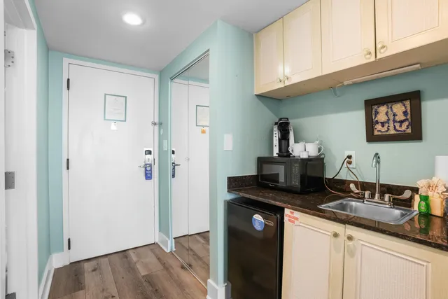 a kitchen with granite countertop a sink stainless steel appliances and cabinets