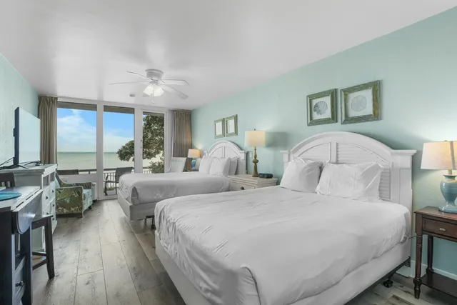 a bedroom with a large bed and a chandelier