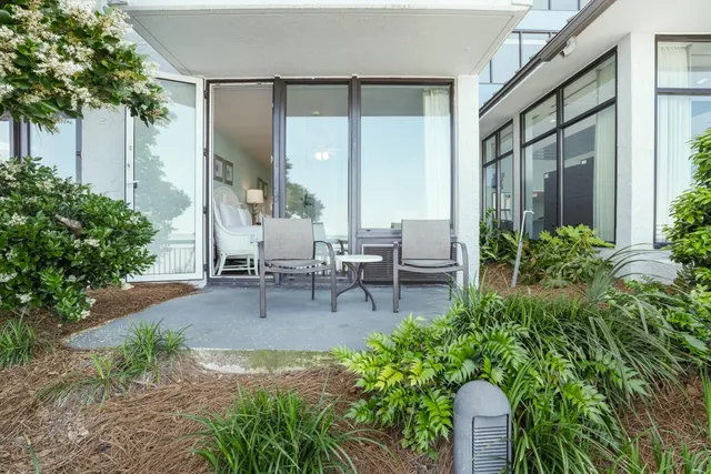 a building outdoor space with patio furniture and potted plants