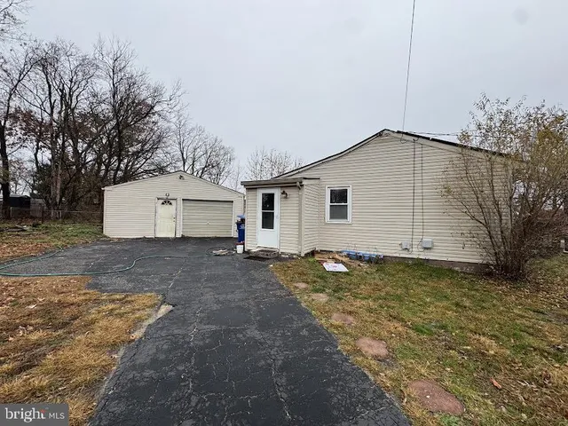 a view of a house with a yard and garage