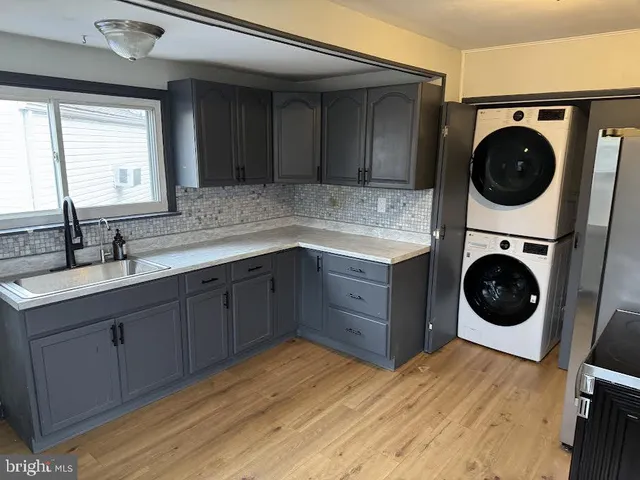a bedroom with a washer and dryer