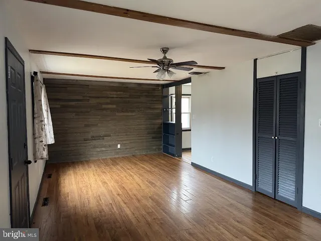 a view of a room with wooden floor and staircase