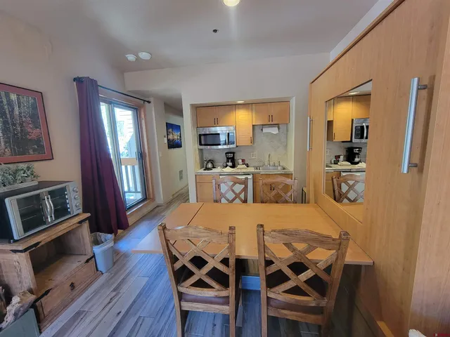 a view of a dining room with furniture and wooden floor