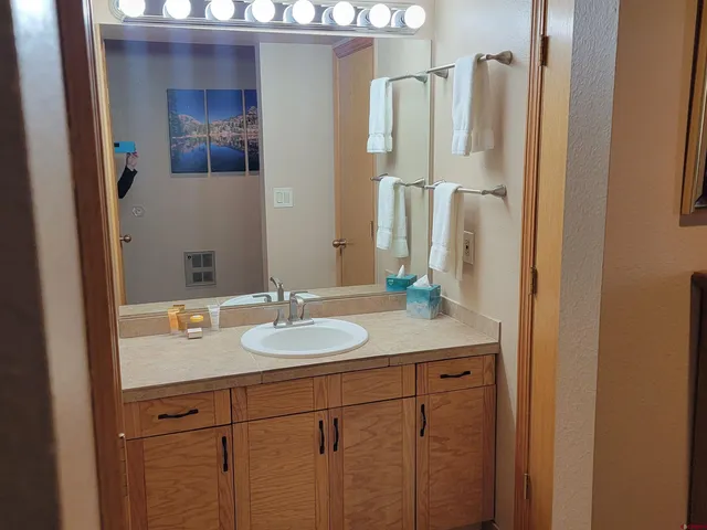 a bathroom with a sink and a mirror