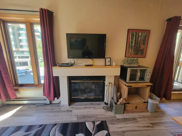 a living room with furniture and a fireplace