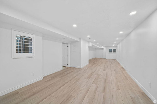 6969 South 855 East Midvale, UT 84047 - Photo 30 of 55 Spacious room featuring wood-finish flooring, recessed lighting, white walls, and white plantation shutters on the windows