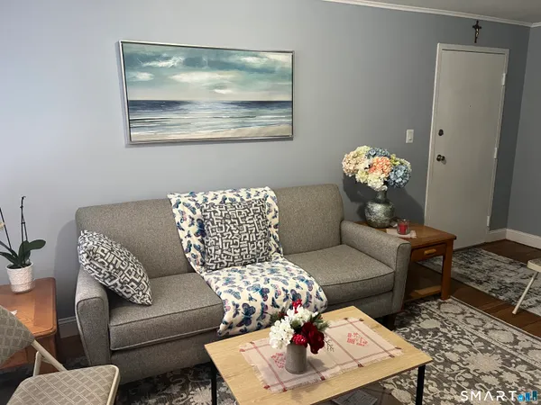 a living room with furniture and wooden floor