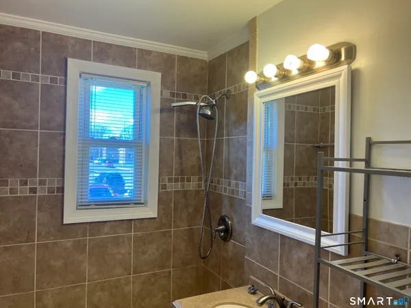 a bathroom with a toilet a sink and shower