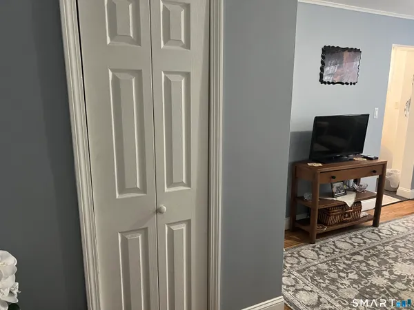 a view of a livingroom with wooden floor and a flat screen tv