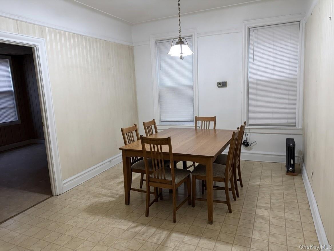1930 Edison Avenue Bronx, NY 10461 - Photo 5 of 9 a view of a dining room with furniture and a chandelier