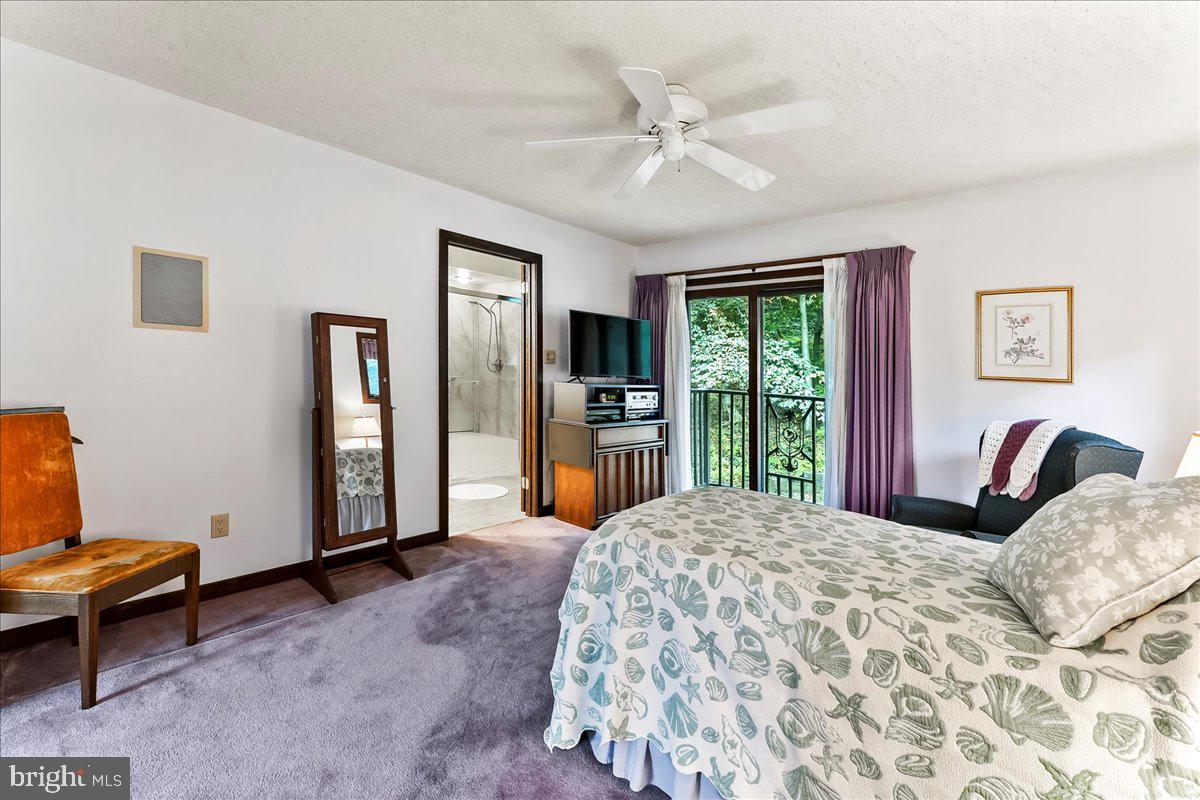 1200 Dunsinane Hill Chester Springs, PA 19425 - Photo 14 of 42 a bedroom with a large bed and a window