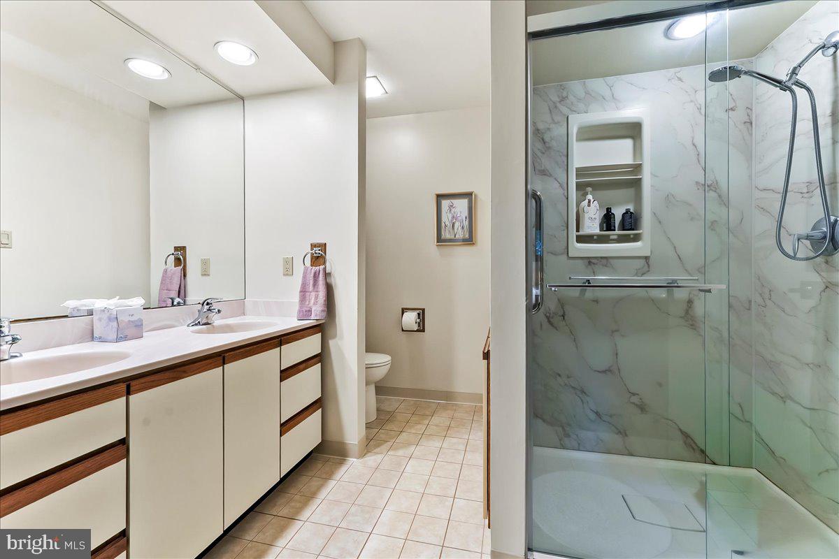 1200 Dunsinane Hill Chester Springs, PA 19425 - Photo 16 of 42 a spacious bathroom with a double vanity sink a mirror and a shower
