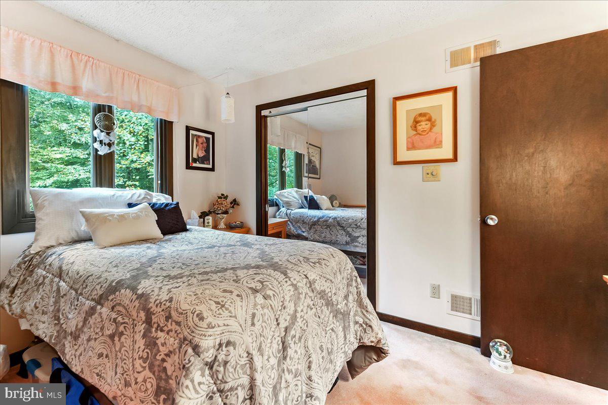 1200 Dunsinane Hill Chester Springs, PA 19425 - Photo 17 of 42 a bed room with a bed and a painting