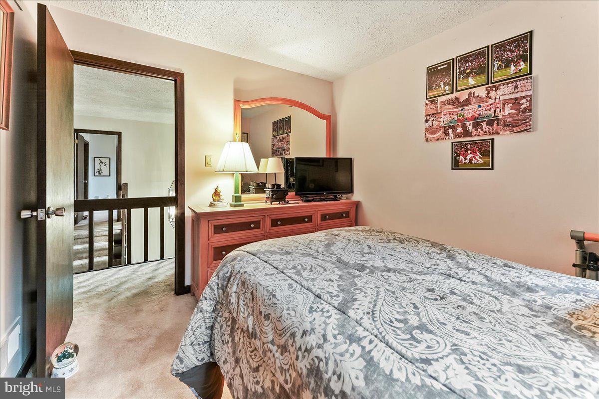 1200 Dunsinane Hill Chester Springs, PA 19425 - Photo 18 of 42 a bedroom with a bed and a flat screen tv