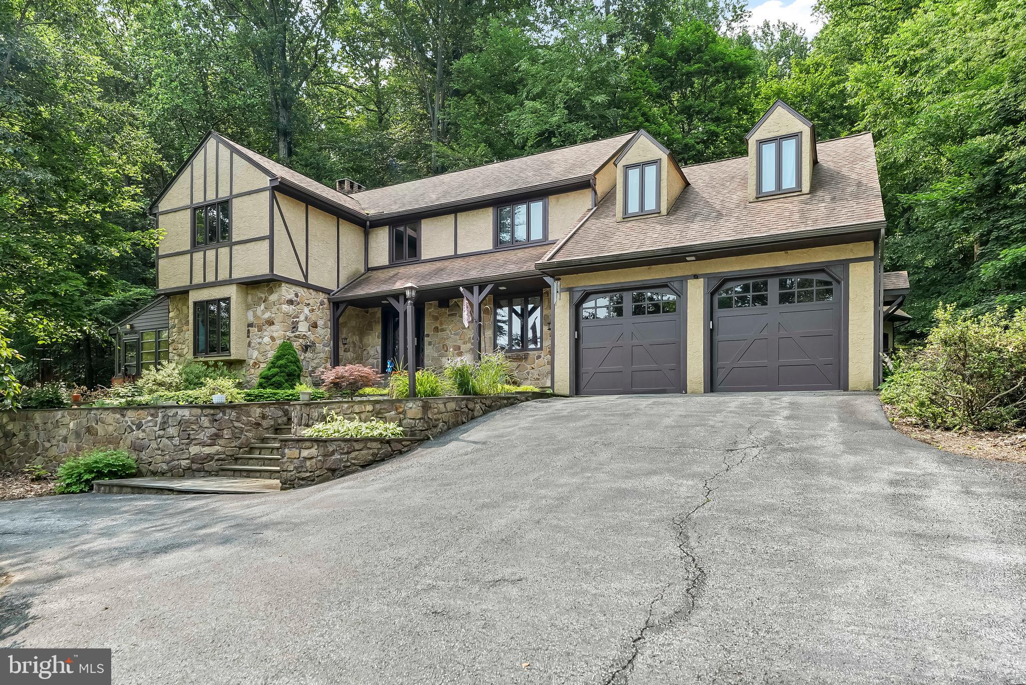 1200 Dunsinane Hill Chester Springs, PA 19425 - Photo 24 of 42 a front view of a house with garden and plants