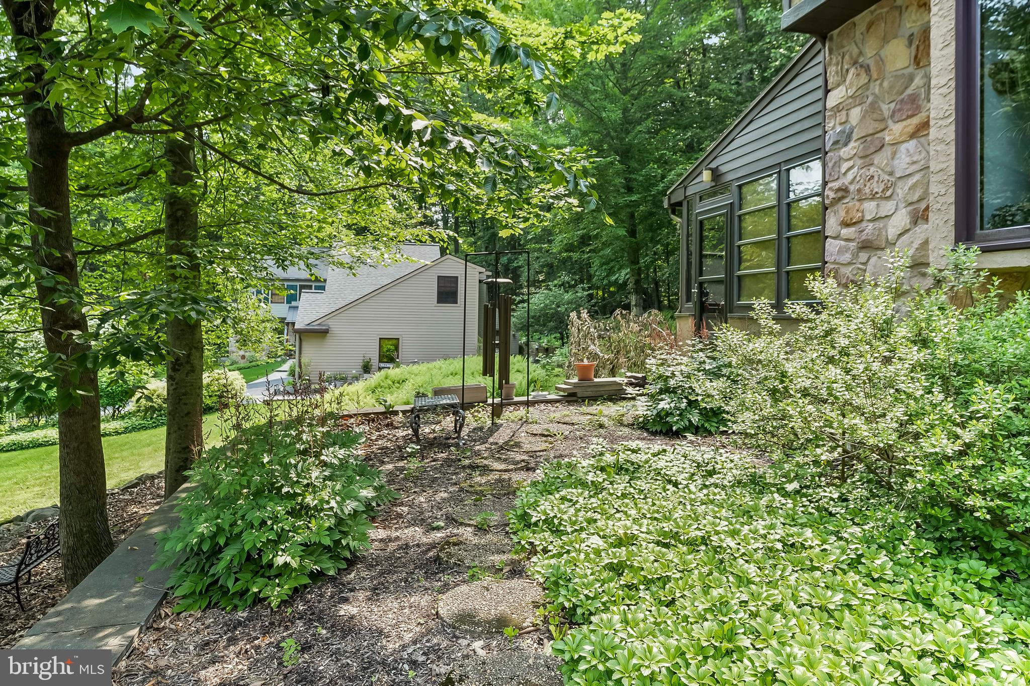 1200 Dunsinane Hill Chester Springs, PA 19425 - Photo 35 of 42 a backyard of a house with plants and large tree