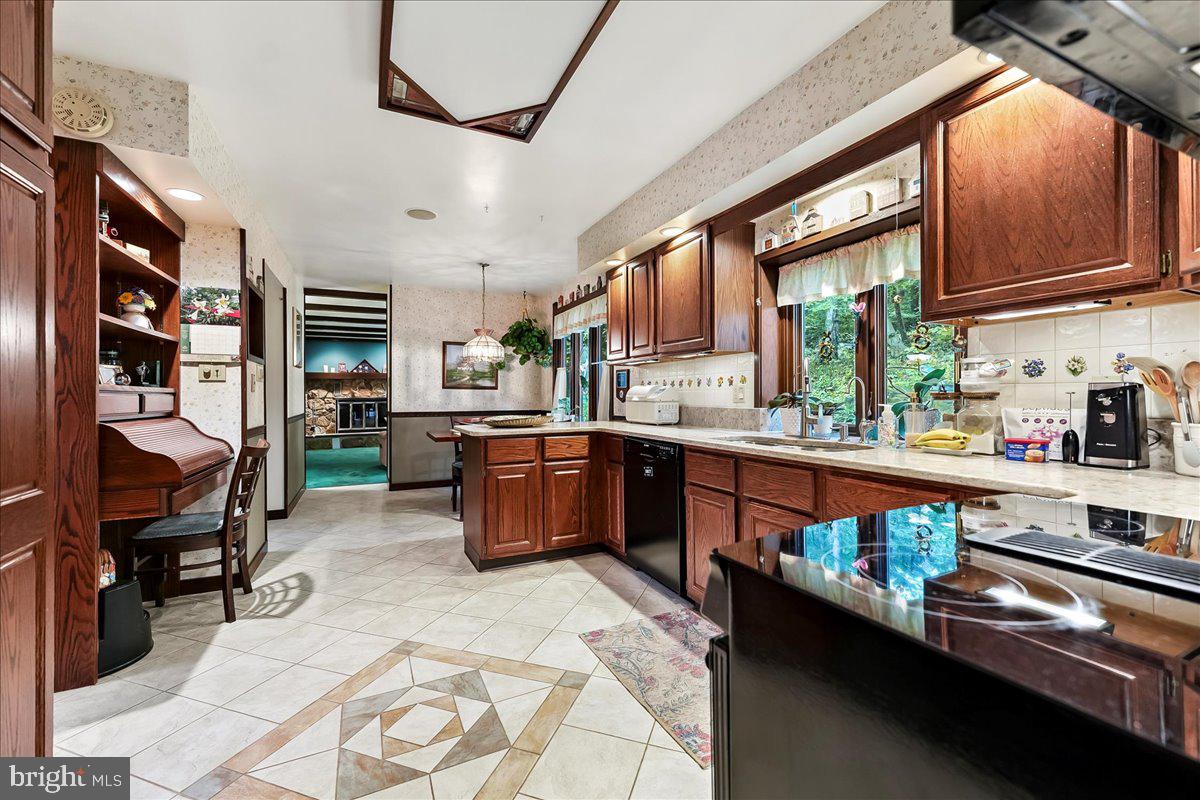 1200 Dunsinane Hill Chester Springs, PA 19425 - Photo 7 of 42 a kitchen with stainless steel appliances granite countertop sink stove and cabinets