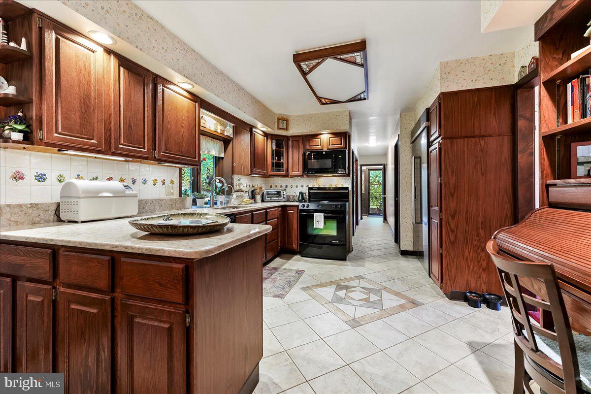 1200 Dunsinane Hill Chester Springs, PA 19425 - Photo 8 of 42 a kitchen with stainless steel appliances granite countertop a sink stove and cabinets