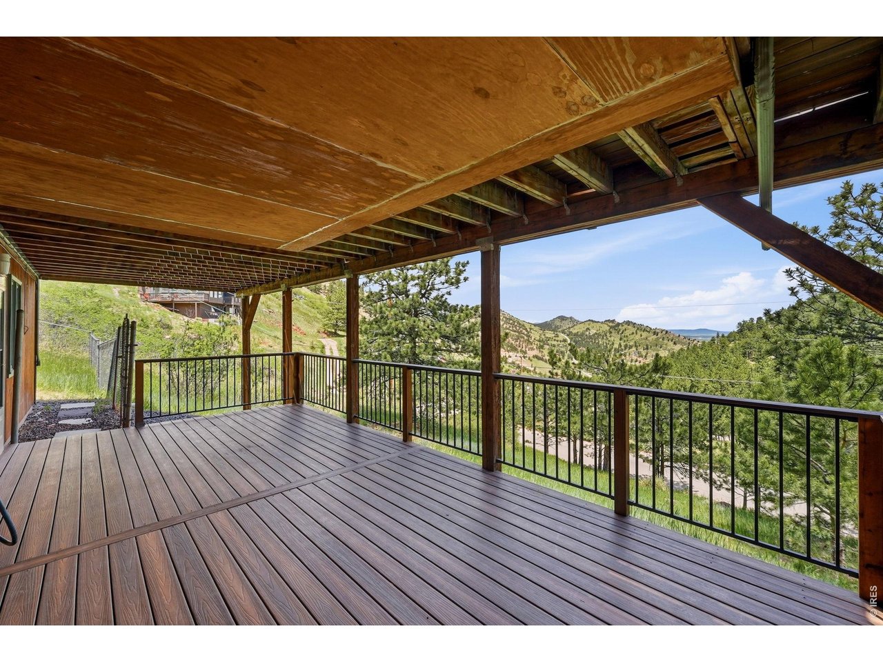 607 North Cedar Brook Road Boulder, CO 80304 - Photo 27 of 36 Lower level composite deck leads to the enclosed yard space and lower level entry and access to the driveway