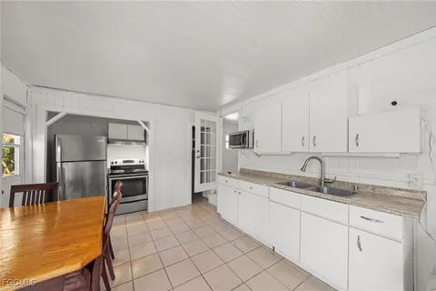 a kitchen with a sink cabinets and refrigerator