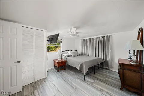 a bedroom with a bed and a dresser in it