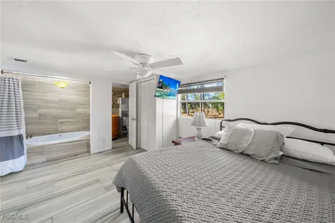 a bedroom with a large bed and a large window