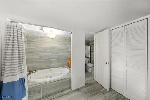 a bathroom with a tub shower and vanity