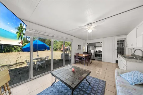 a living room with furniture a table and chairs
