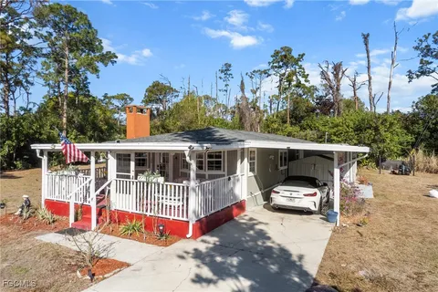a view of a house with a yard and sitting area