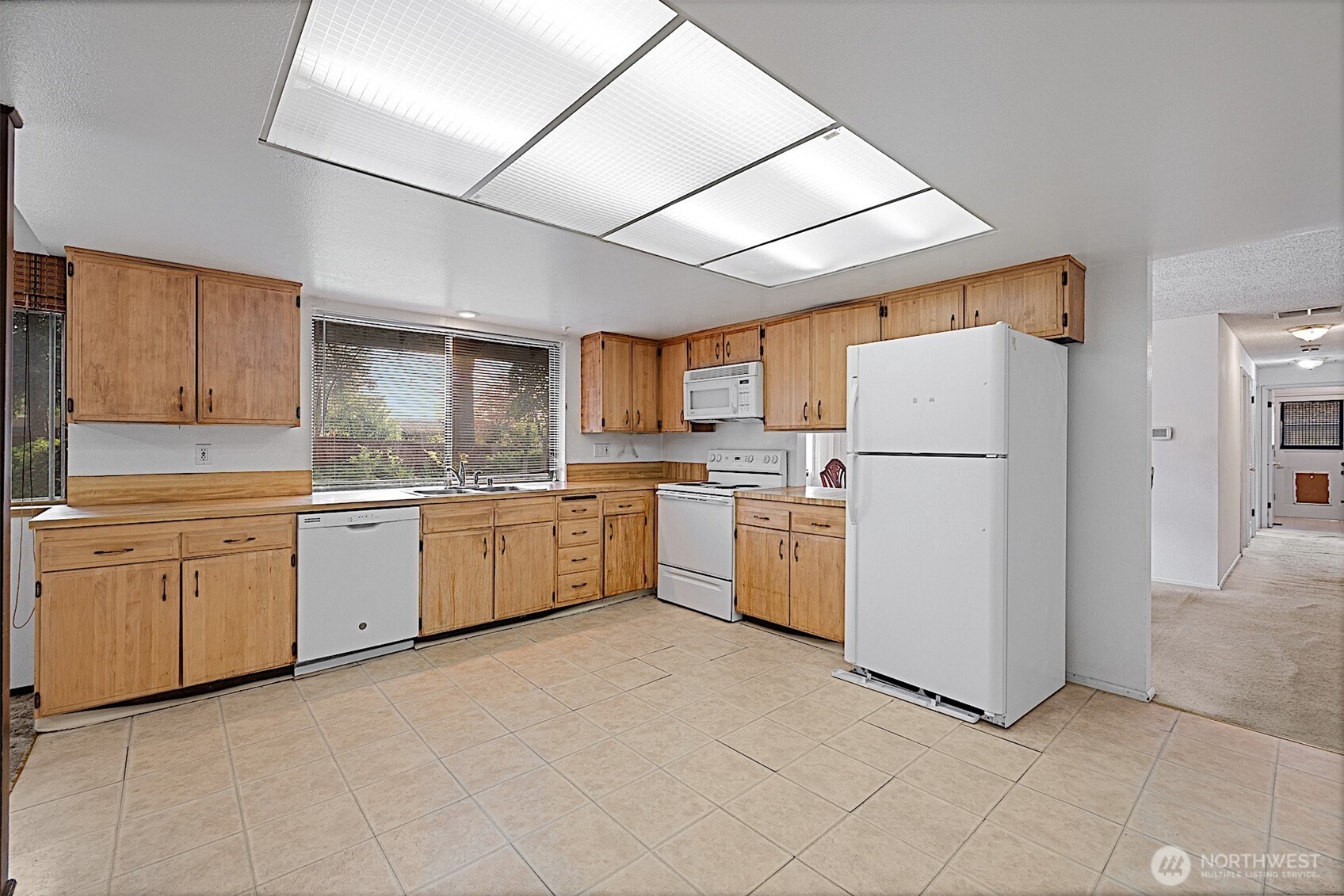 7407 Onyx Drive Southwest Lakewood, WA 98498 - Photo 11 of 40 a kitchen with cabinets a sink and white stainless steel appliances