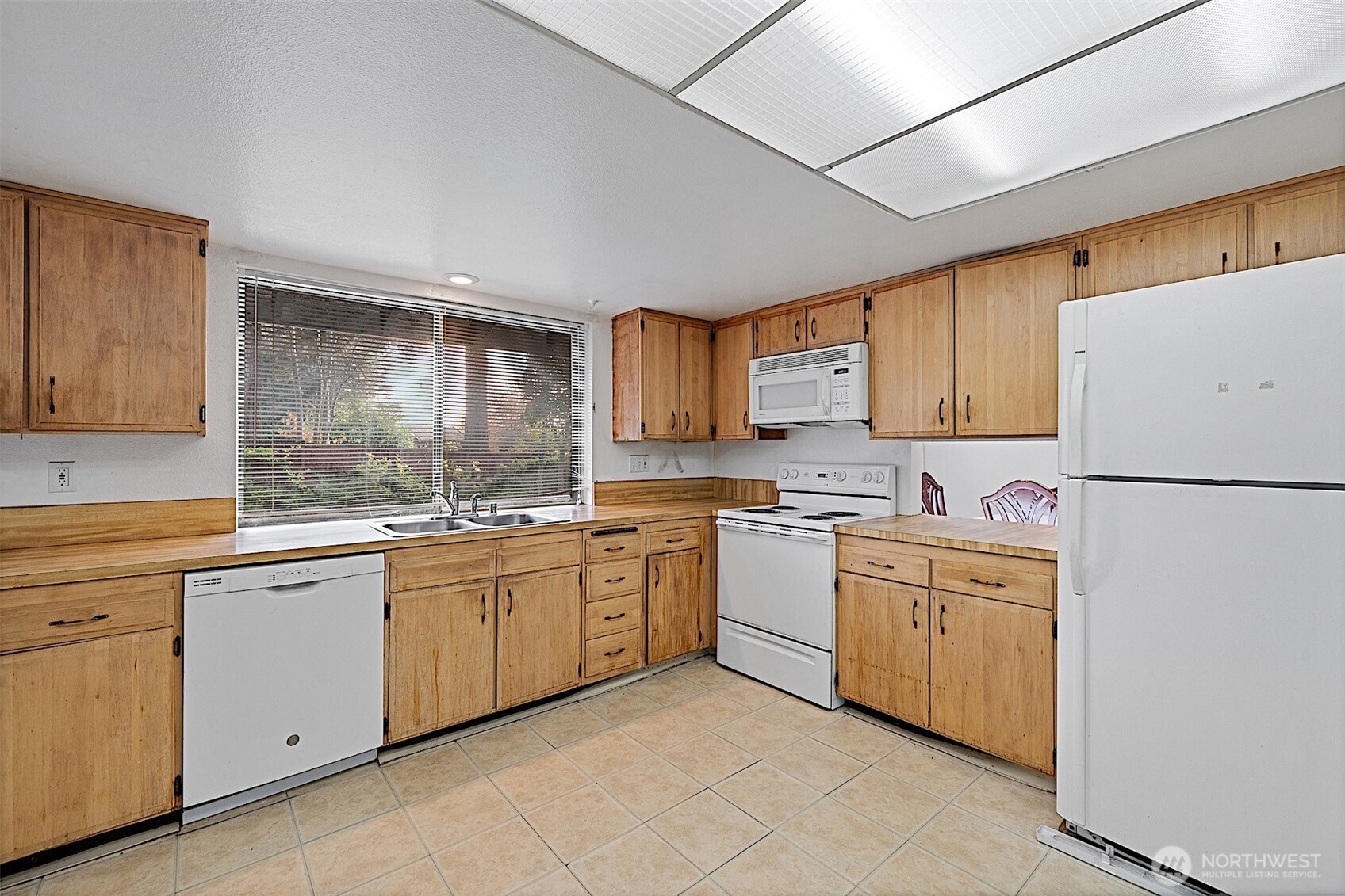 7407 Onyx Drive Southwest Lakewood, WA 98498 - Photo 12 of 40 a kitchen with white cabinets sink and white appliances