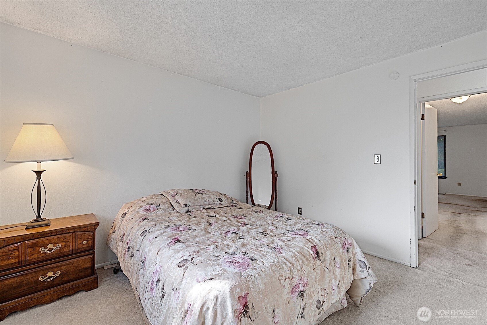 7407 Onyx Drive Southwest Lakewood, WA 98498 - Photo 18 of 40 a bedroom with a bed and a lamp on the dresser