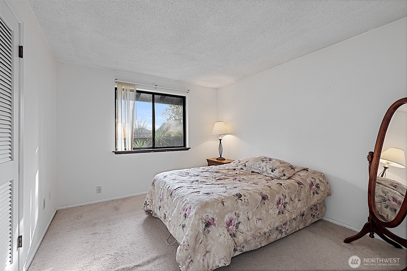 7407 Onyx Drive Southwest Lakewood, WA 98498 - Photo 19 of 40 a bedroom with a bed and a window