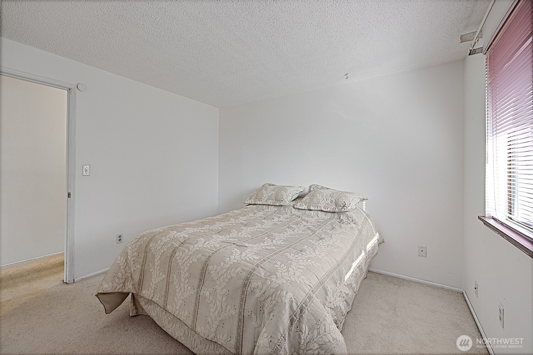 7407 Onyx Drive Southwest Lakewood, WA 98498 - Photo 21 of 40 a bed sitting in a bedroom next to a window