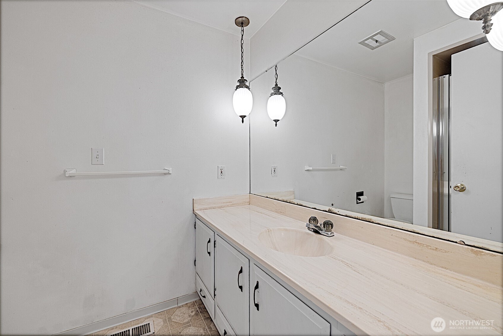 7407 Onyx Drive Southwest Lakewood, WA 98498 - Photo 28 of 40 a bathroom with a sink and a mirror