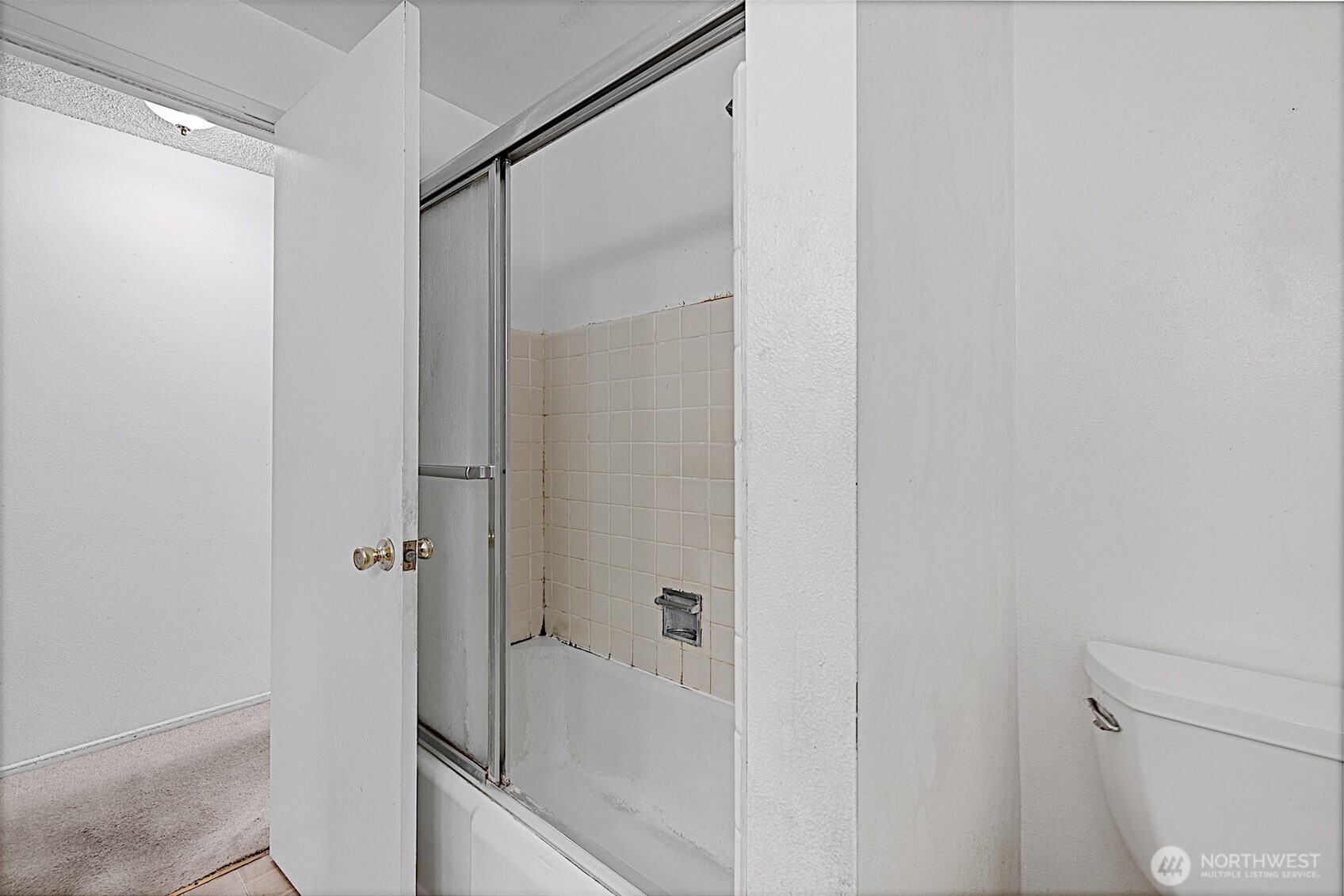 7407 Onyx Drive Southwest Lakewood, WA 98498 - Photo 33 of 40 a bathroom with a glass shower door