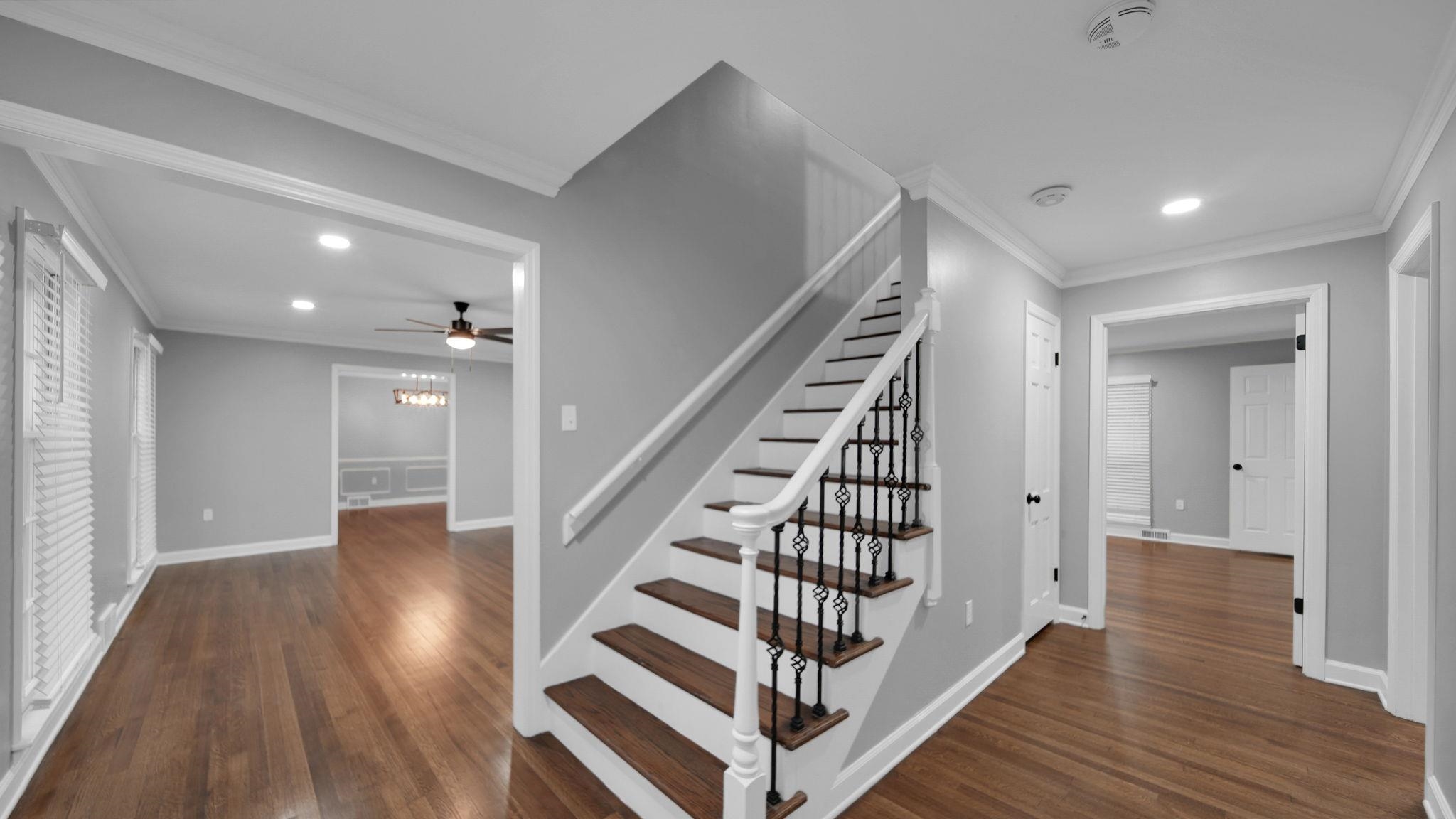 5256 Collingwood Road Memphis, TN 38117 - Photo 9 of 40 Stairway featuring ornamental molding, wood finished floors, recessed lighting, and a chandelier